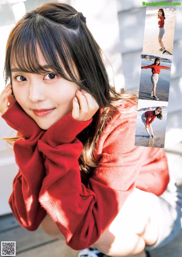 A woman in a red sweater is posing for a picture.