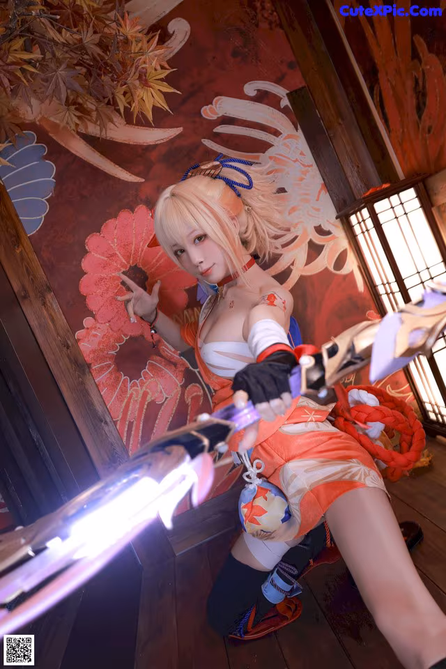 A woman in a red and white outfit holding a sword.