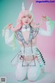 A woman in a white outfit with pink hair and horns.