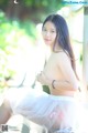 A young woman in a white tutu posing for the camera.