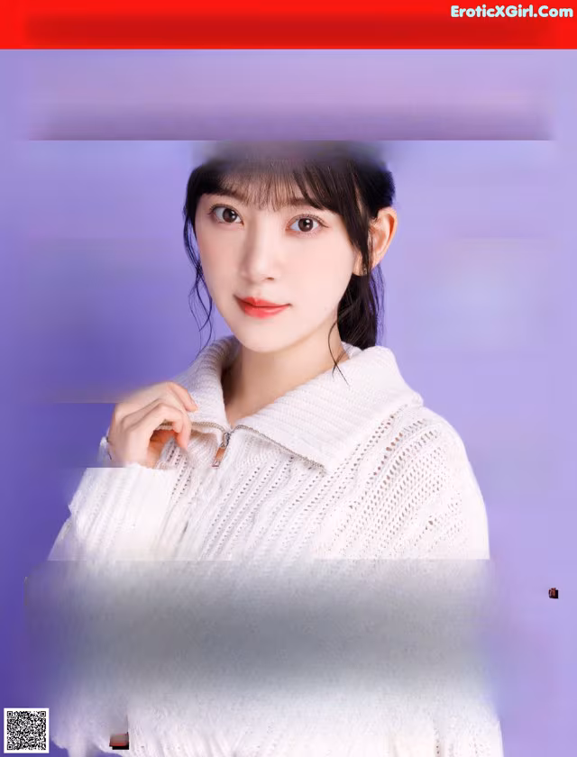 A magazine with a woman in a white sweater on the cover.
