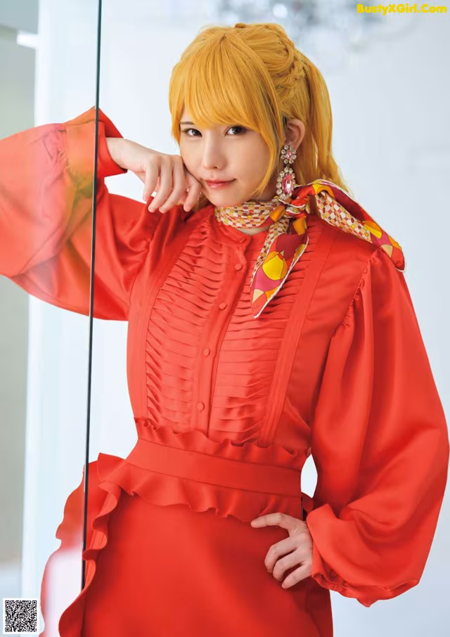 A woman in a red dress posing for a picture.